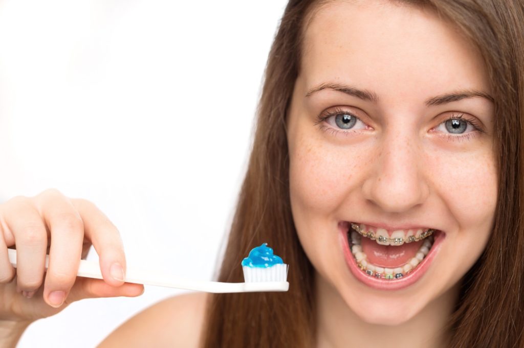 teen girl brushing teeth
